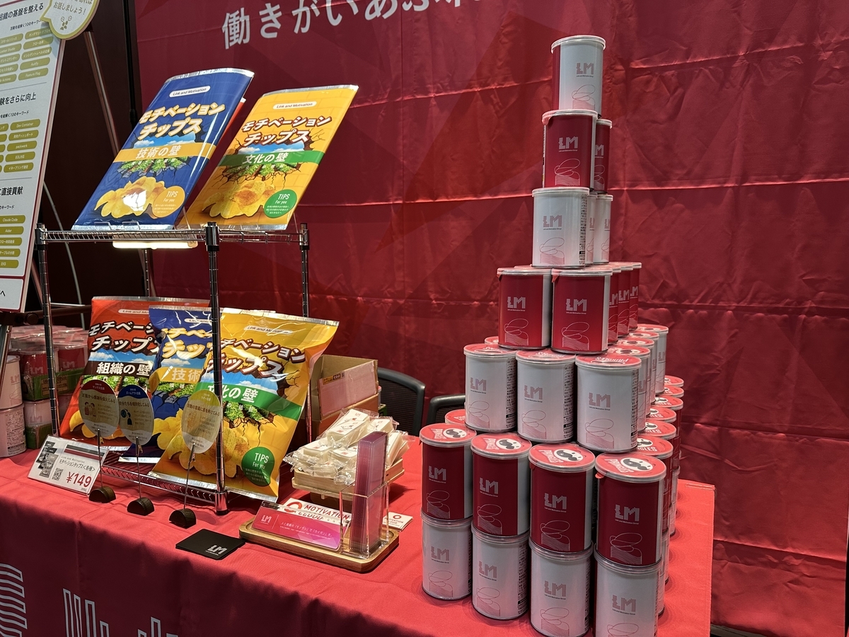 リンクアンドモチベーションがPEK2025のブースで用意した筒状のポテトチップスが、高く積み上げられている写真。